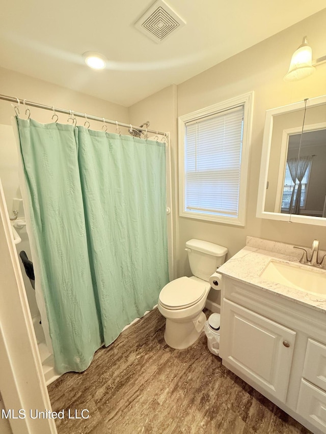 588 Robin Rd, Grenada, MS 38901 - bathroom with a shower with curtain, wood-type flooring, toilet, and vanity