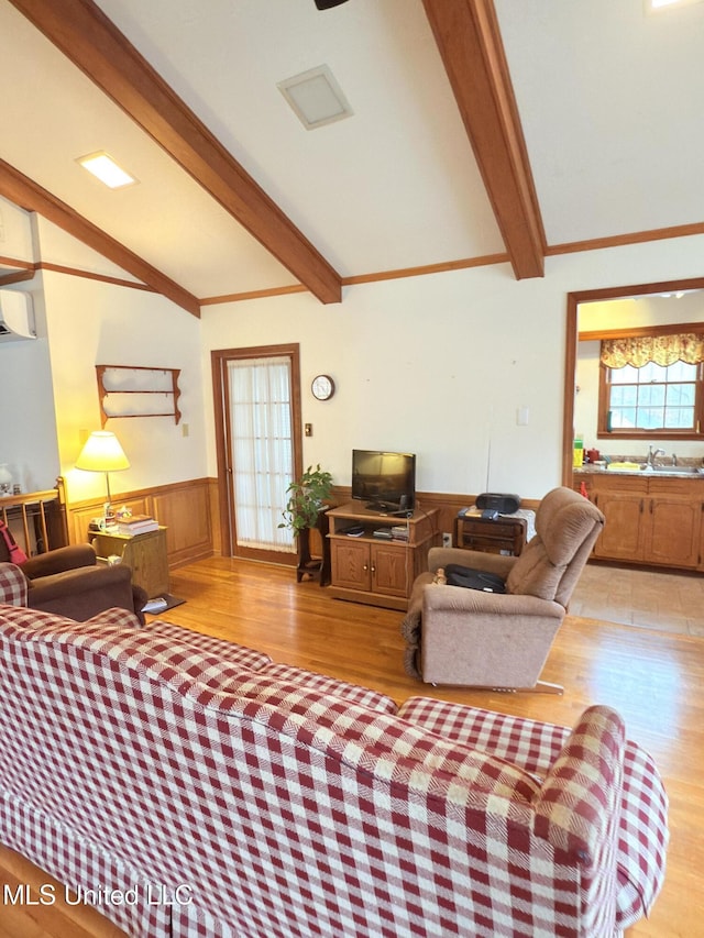 588 Robin Rd, Grenada, MS 38901 - living room with lofted ceiling with beams, an AC wall unit, sink, and light wood-type flooring