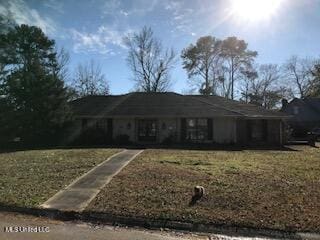 ranch-style home with a front lawn