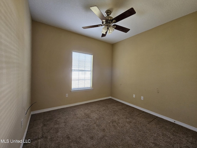 unfurnished room featuring ceiling fan and dark carpet