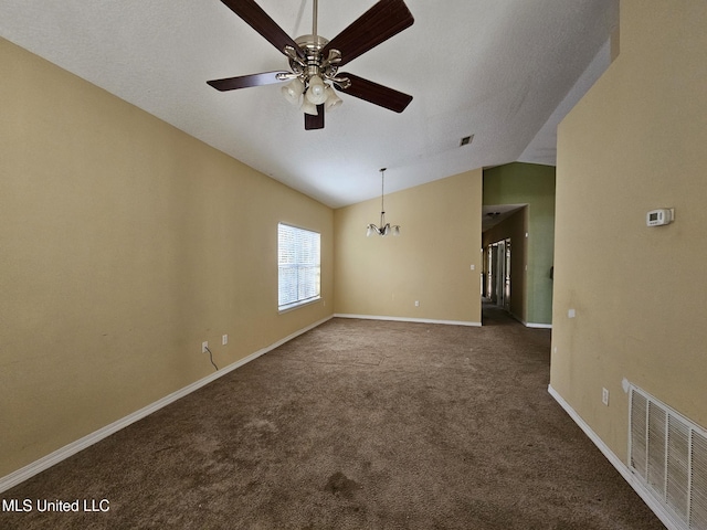 carpeted empty room featuring ceiling fan with notable chandelier and lofted ceiling