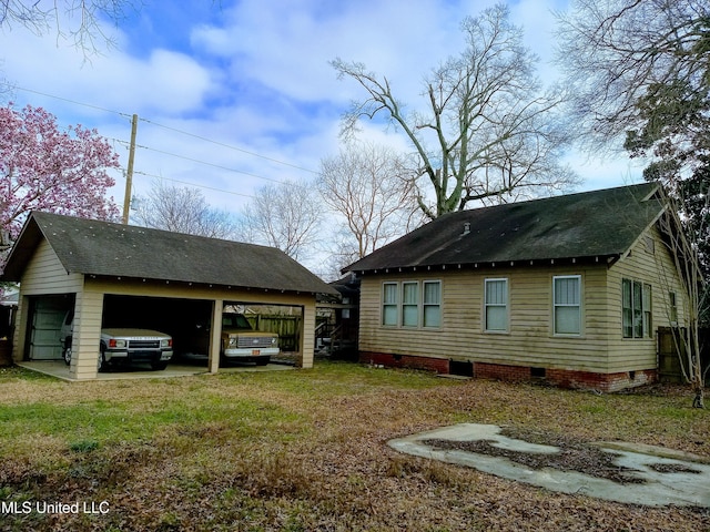 309 E Percy St, Indianola, MS 38751 - view of side of home featuring a carport