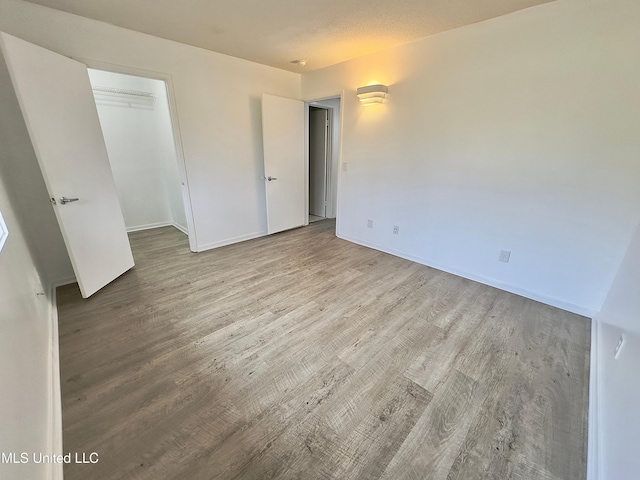 unfurnished bedroom featuring baseboards and wood finished floors