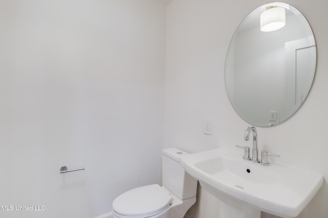 bathroom with toilet and a sink