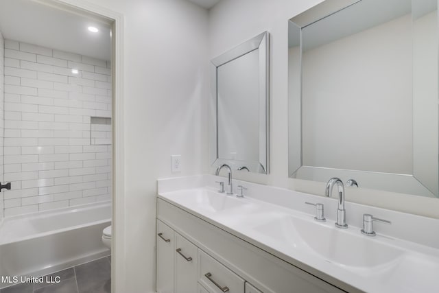 full bathroom featuring tile patterned flooring, double vanity, toilet, and a sink