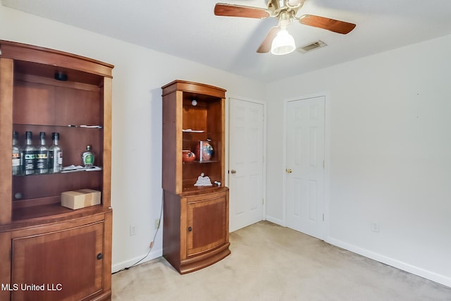 interior space with ceiling fan and bar