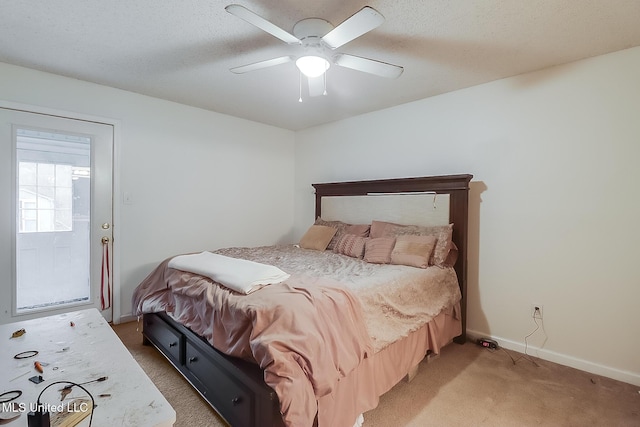 carpeted bedroom with a textured ceiling and ceiling fan