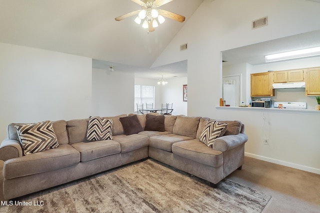 living room with carpet flooring, ceiling fan with notable chandelier, and high vaulted ceiling