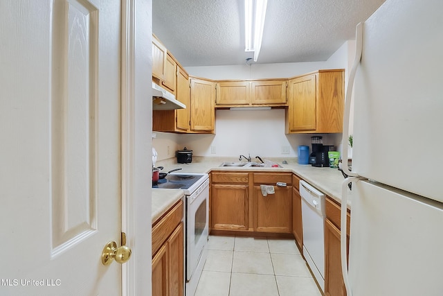 kitchen featuring a textured ceiling, light tile patterned floors, sink, and white appliances