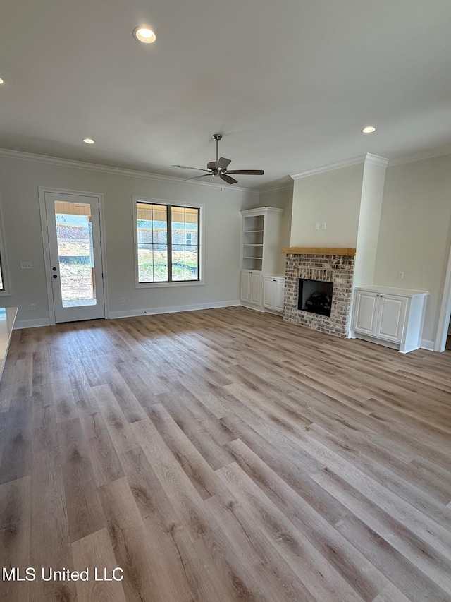 409 Butternut Dr, Canton, MS 39046 - unfurnished living room featuring ornamental molding, a ceiling fan, recessed lighting, light wood finished floors, and baseboards