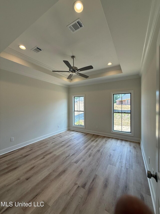 409 Butternut Dr, Canton, MS 39046 - empty room with a tray ceiling, ornamental molding, baseboards, wood finished floors, and recessed lighting