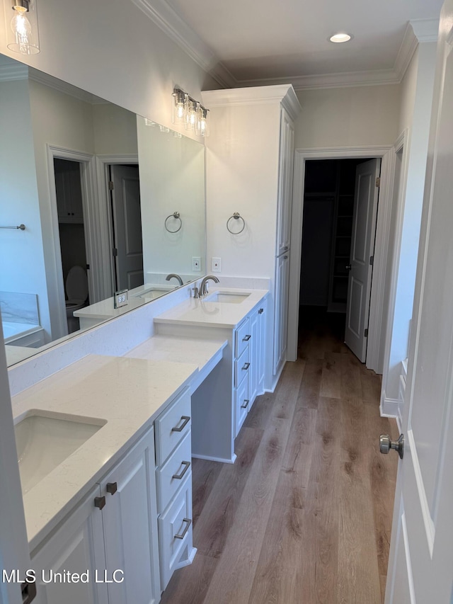 409 Butternut Dr, Canton, MS 39046 - bathroom with double vanity, crown molding, wood finished floors, recessed lighting, and toilet