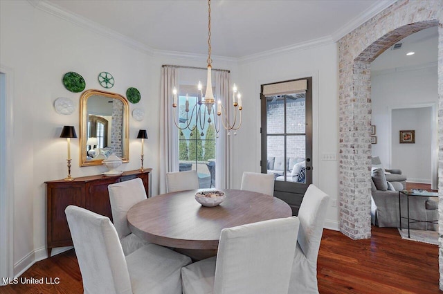 dining area with a notable chandelier, dark wood-style floors, baseboards, and ornamental molding