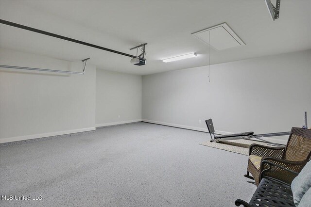 garage with a garage door opener and baseboards