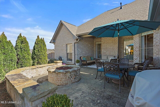 view of patio / terrace with outdoor dining area and an outdoor fire pit