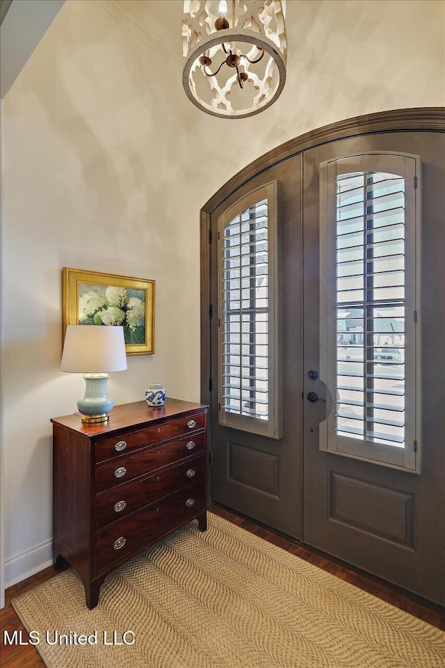 entryway featuring french doors, baseboards, and light wood-style floors