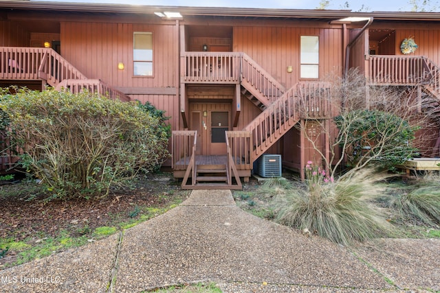 rear view of property with central AC