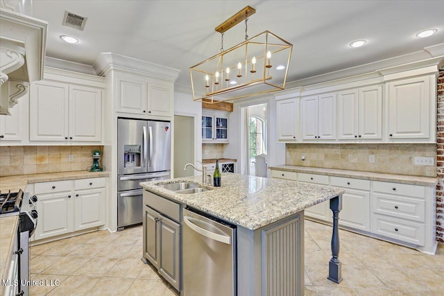 kitchen with a sink, appliances with stainless steel finishes, light tile patterned floors, and visible vents