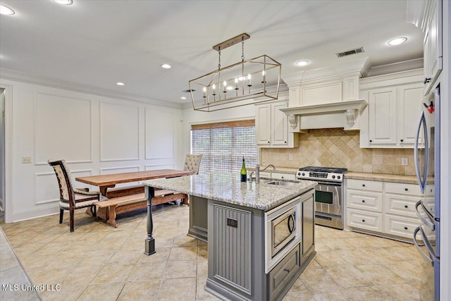 kitchen with visible vents, gray cabinetry, a sink, stainless steel appliances, and white cabinetry