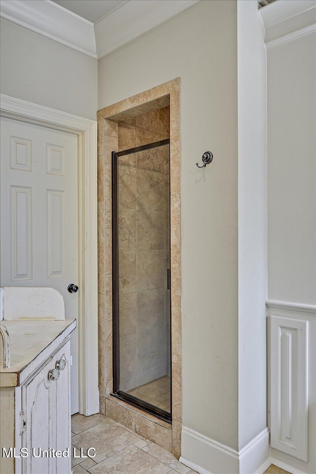 full bathroom featuring vanity, ornamental molding, and a stall shower