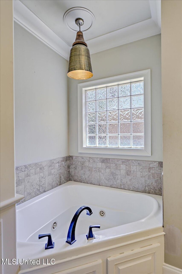 bathroom with a whirlpool tub and a healthy amount of sunlight