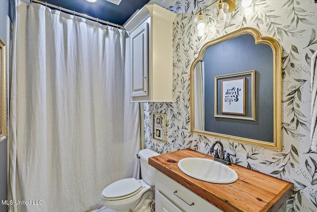 full bathroom with vanity, toilet, and wallpapered walls