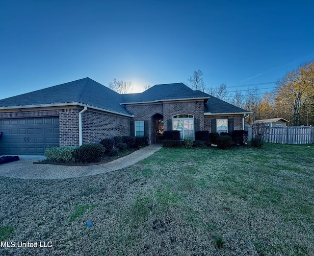 view of front of home featuring a garage and a front yard