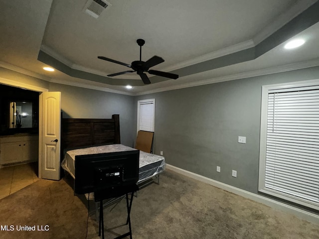 bedroom with a raised ceiling, ornamental molding, and carpet floors