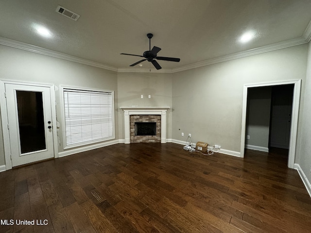 unfurnished living room featuring a fireplace, crown molding, and dark wood-type flooring