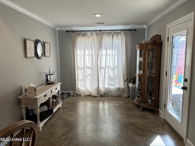 doorway with a healthy amount of sunlight and crown molding