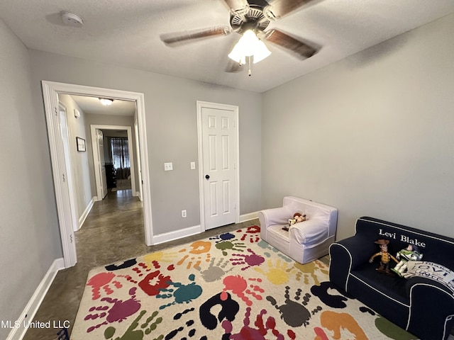 bedroom with ceiling fan and a textured ceiling