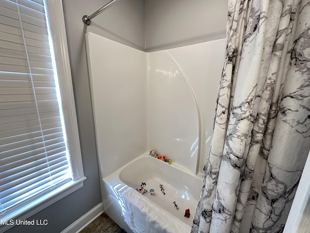 bathroom with shower / tub combo with curtain