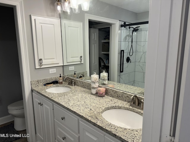 bathroom with vanity, toilet, and an enclosed shower