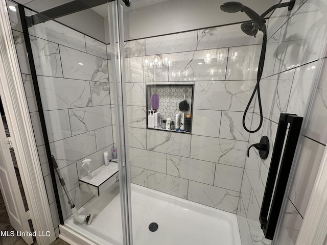 bathroom featuring a shower with door