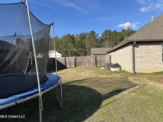 view of yard with cooling unit and a trampoline