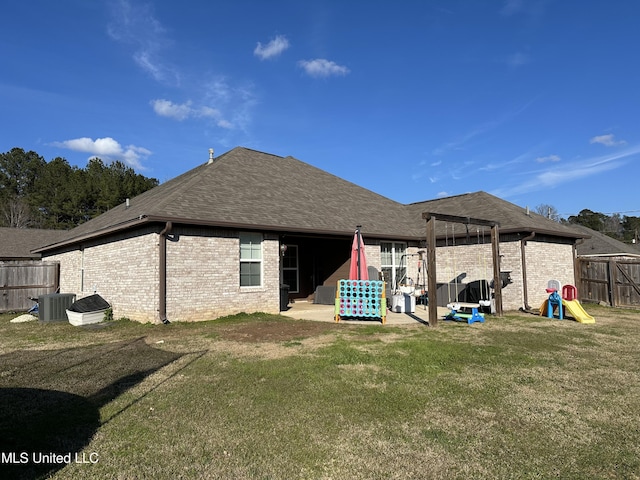 back of property with cooling unit, a patio area, and a lawn