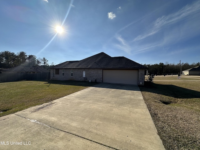 view of front of property with a garage and a front lawn