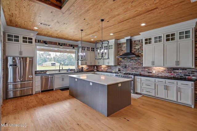 849 Athens Rd, Mendenhall, MS 39114 - kitchen with appliances with stainless steel finishes, wall chimney exhaust hood, wood ceiling, a chandelier, and a kitchen island