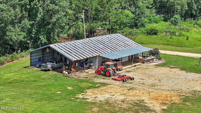 849 Athens Rd, Mendenhall, MS 39114 - view of pole building featuring dirt driveway, a yard, a wooded view, and a carport