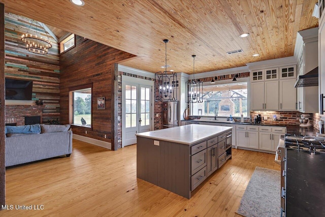849 Athens Rd, Mendenhall, MS 39114 - kitchen featuring wooden ceiling, a chandelier, light wood-style floors, stainless steel appliances, and a kitchen island