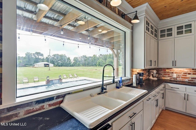 849 Athens Rd, Mendenhall, MS 39114 - kitchen featuring decorative backsplash, glass insert cabinets, and dark countertops