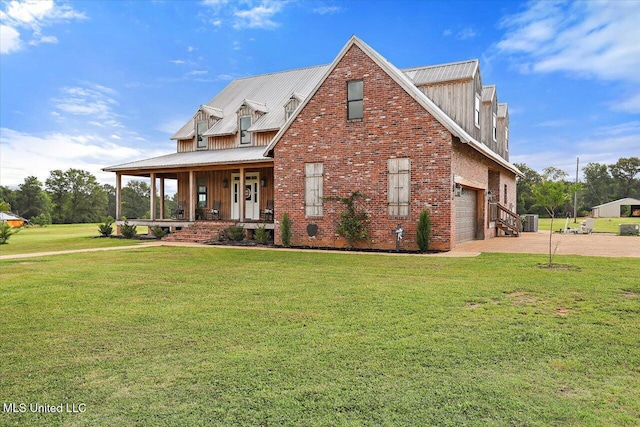 849 Athens Rd, Mendenhall, MS 39114 - view of front of home with covered porch, driveway, a front yard, a garage, and a metal roof