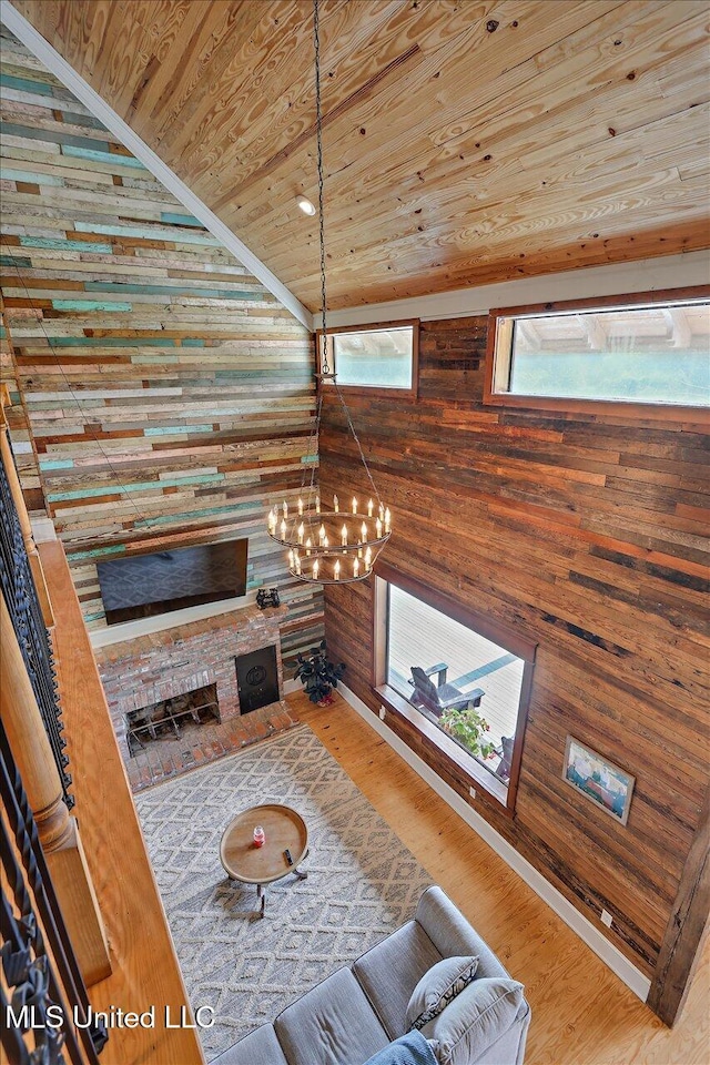 849 Athens Rd, Mendenhall, MS 39114 - living room with wooden ceiling, wood walls, a chandelier, lofted ceiling, and wood finished floors