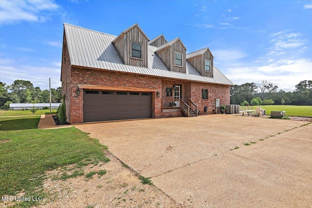 849 Athens Rd, Mendenhall, MS 39114 - new england style home featuring brick siding, driveway, an attached garage, and a front lawn
