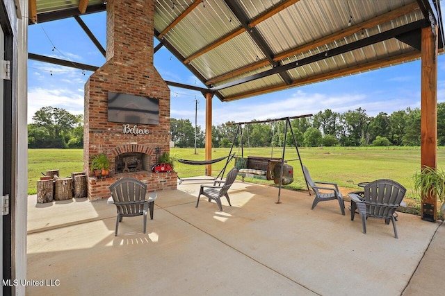 849 Athens Rd, Mendenhall, MS 39114 - view of patio / terrace featuring an outdoor brick fireplace and view of scattered trees