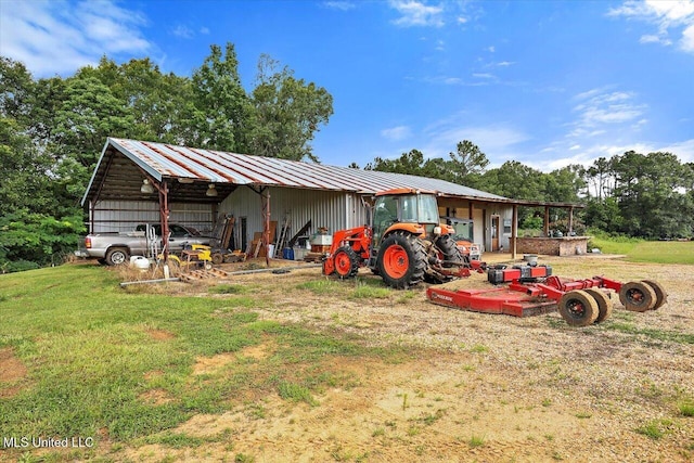 849 Athens Rd, Mendenhall, MS 39114 - rear view of property with a pole building, a metal roof, an outdoor structure, and a lawn