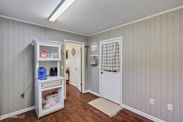 849 Athens Rd, Mendenhall, MS 39114 - entryway featuring dark wood-style floors, wood walls, a textured ceiling, and crown molding