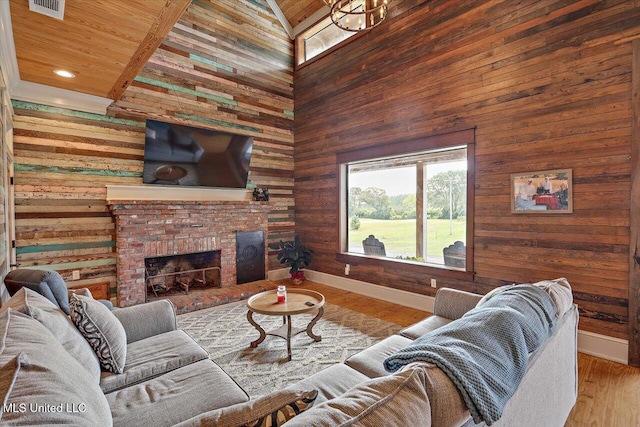 849 Athens Rd, Mendenhall, MS 39114 - living room featuring wood walls, high vaulted ceiling, a fireplace, wood finished floors, and wood ceiling