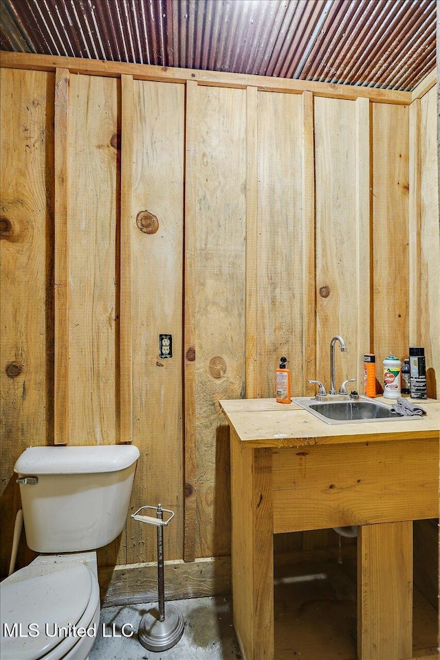 849 Athens Rd, Mendenhall, MS 39114 - bathroom featuring vanity, unfinished concrete flooring, and wood walls