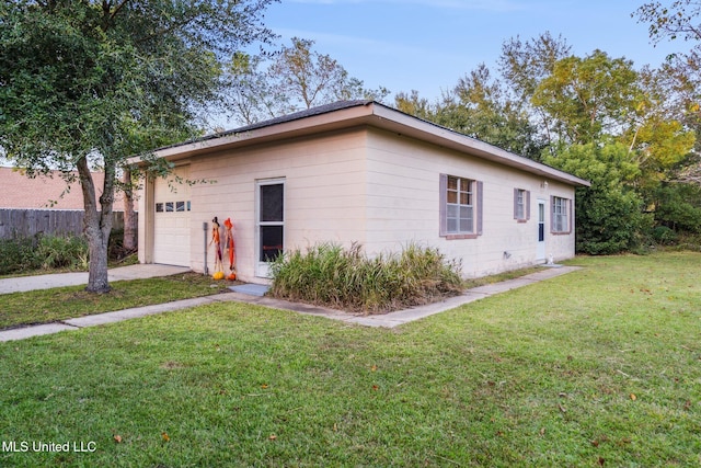 exterior space with a garage and a yard